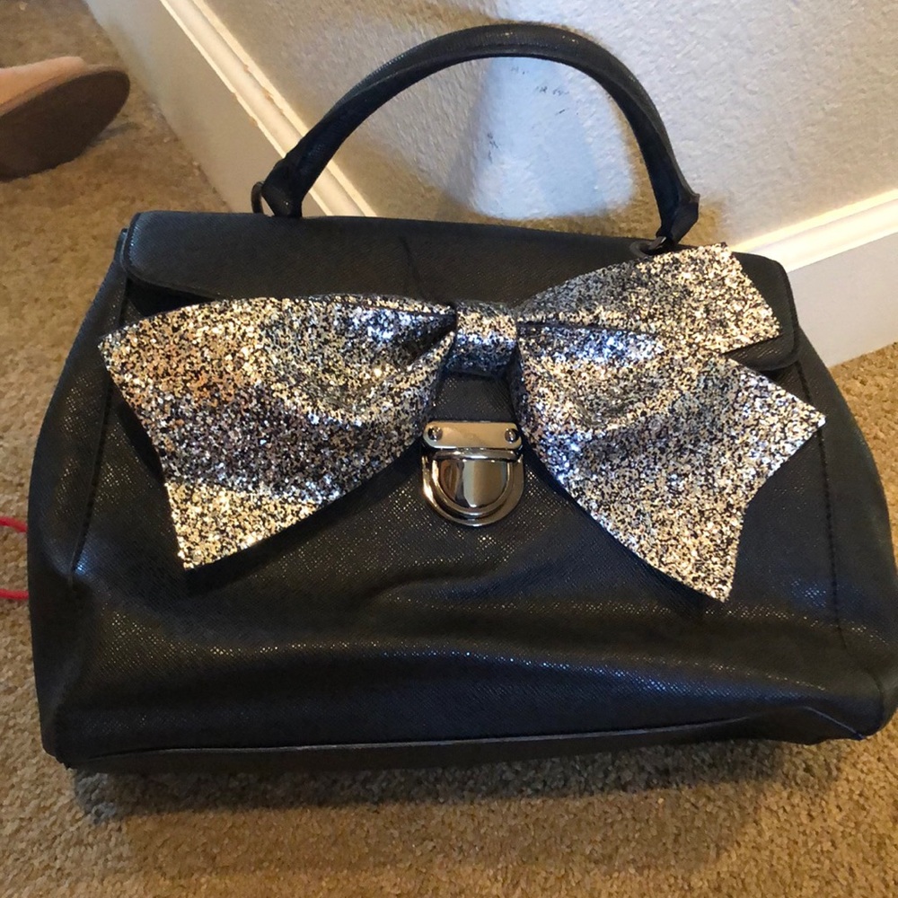 black purse with silver bow